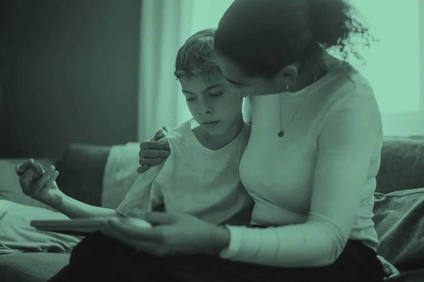 A parent and child looking at a phone together