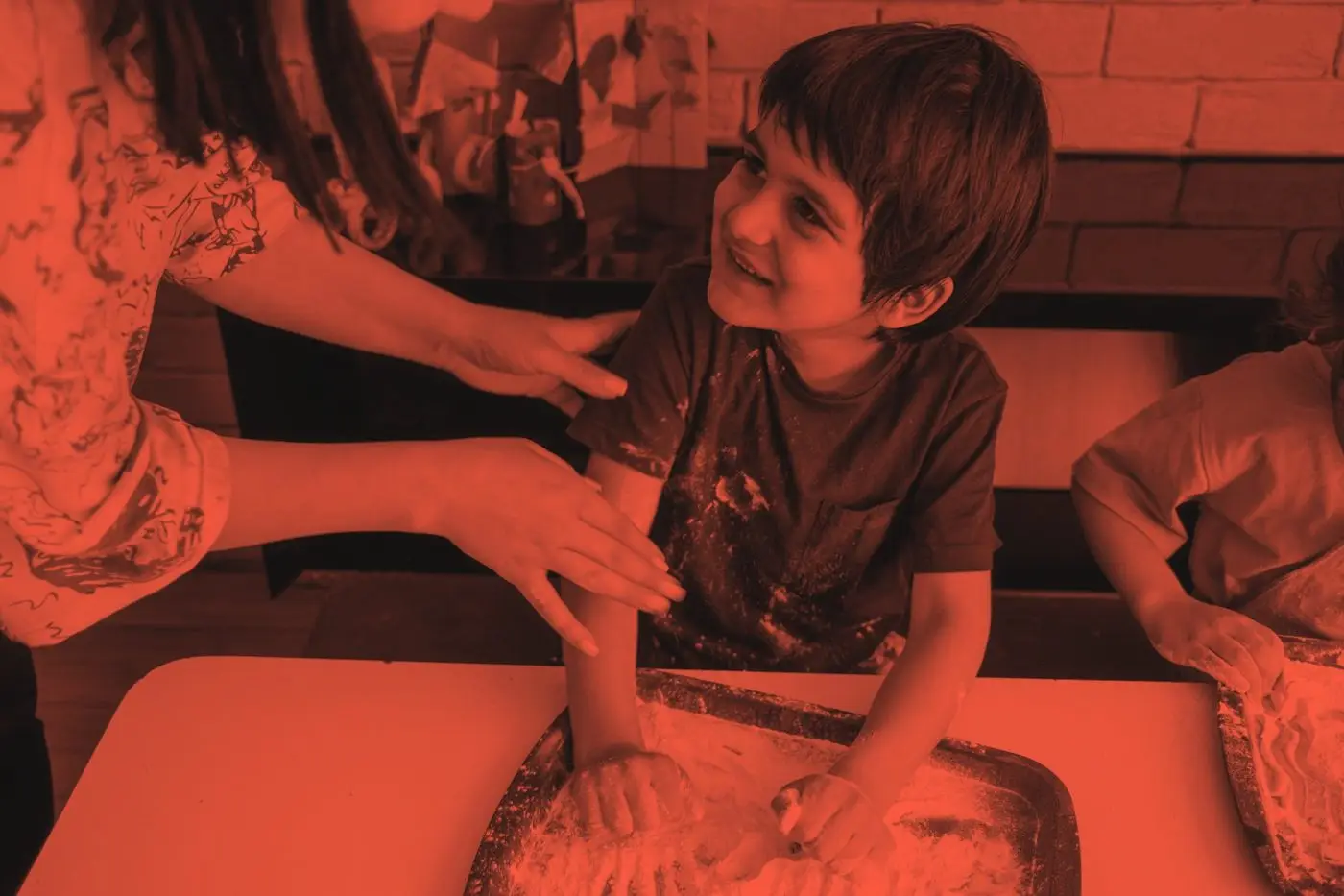 An adult and child laughing together at a table